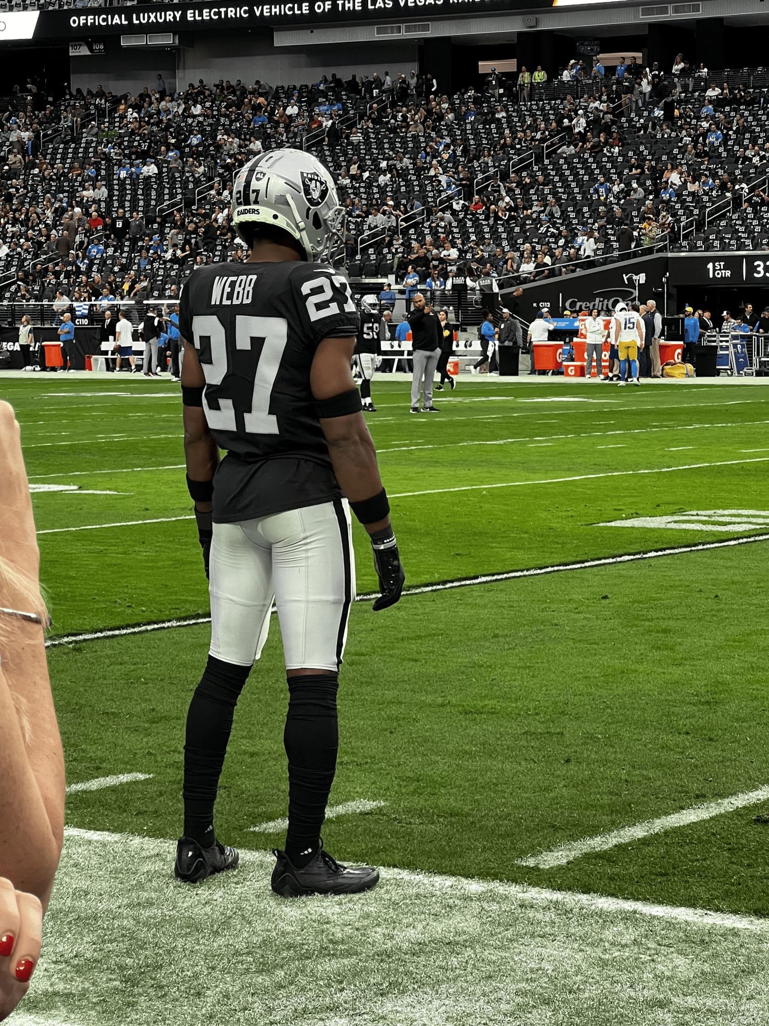 Reliance client Samuel Webb in his #27 jersey looking out over an NFL stadium
